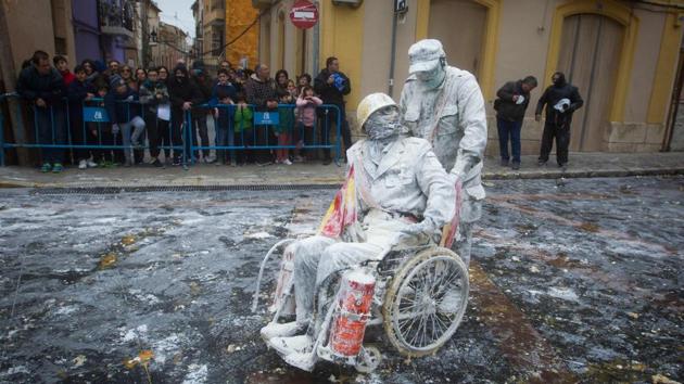 As the clock strikes five, Ibi skips into the present, the takeover complete and peace restored. The brief rule of the Els Enfarinats gives way to traditional dances and the town is spared a cakey mess for another year. (Jaime Reina / AFP) As the clock strikes five, Ibi skips into the present, the takeover complete and peace restored. The brief rule of the Els Enfarinats gives way to traditional dances and the town is spared a cakey mess for another year. (Jaime Reina / AFP)