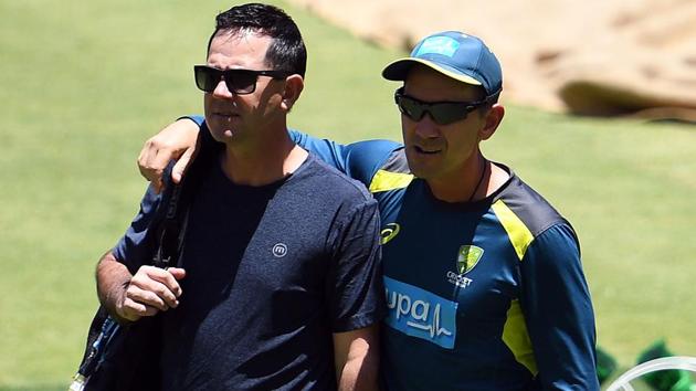 Ricky Ponting (L) and Australia's coach Justin Langer walk in the ground.(AFP)