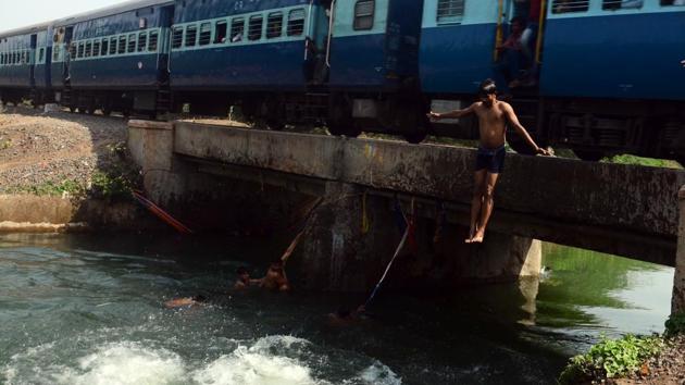 Children jump into a canal near Ghorpadi to escape the scorching heat of summer on May 19 (SHANKAR NARYAN ) 