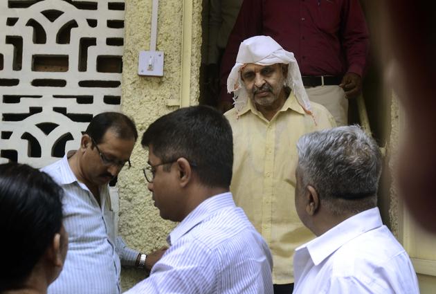 Pune, India - March 14, 2018: Milind Ekbote (In White scarf and cap) arrested from his residence at Shivajinagar by Pune Rural Police after his bail plea was rejected by court in the Koregaon Bhima violance case (Shalaka Shinde story) in Pune, India, on Wednesday, March 14, 2018. (Photo by Ravindra Joshi/HT PHOTO) 