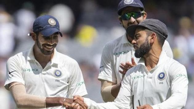 India's captain Virat Kohli, right, shakes hands with Jasprit Bumrah after Bumrah got 6 wickets during play on day three of the third Test against Australia.(AP)