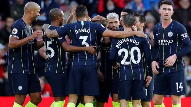 Manchester City's Sergio Aguero celebrates with team mates after scoring their third goal.(REUTERS)