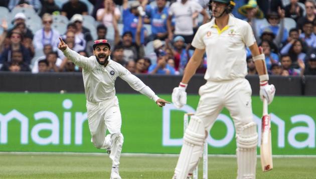 India's Virat Kohli, left, reacts after getting the wicket of Australia's Pat Cummins during play on day five of the third cricket test between India and Australia in Melbourne, Australia, Sunday, Dec. 30, 2018(AP)