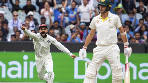 India's Virat Kohli, left, reacts after getting the wicket of Australia's Pat Cummins during play on day five of the third cricket test between India and Australia in Melbourne. (AP) India's Virat Kohli, left, reacts after getting the wicket of Australia's Pat Cummins during play on day five of the third cricket test between India and Australia in Melbourne. (AP)