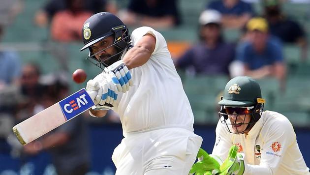Rohit Sharma plays a shot as Australia's wicketkeeper Tim Paine (right) looks on during day two of the third Test. (AFP) Rohit Sharma plays a shot as Australia's wicketkeeper Tim Paine (right) looks on during day two of the third Test. (AFP)