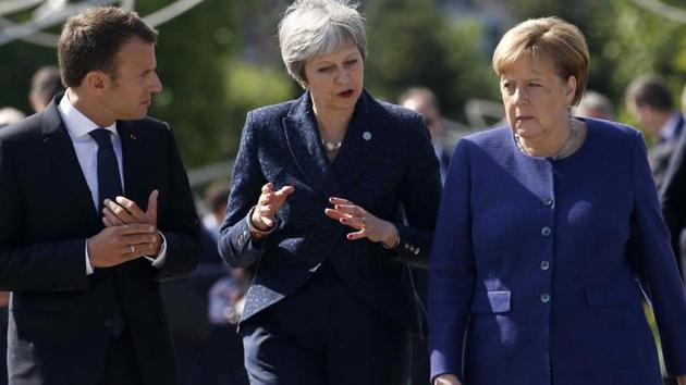British Prime Minister Theresa May (C), German Chancellor Angela Merkel (R) and French President Emmanuel Macron. (AP)