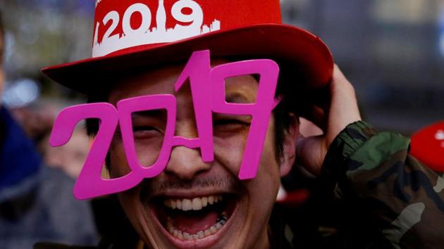 A man wears glasses shaped as the year 2019 as he attends a New Year countdown event at Shibuya crossing in Tokyo, Japan. (Kim Kyung-Hoon / Reuters) 