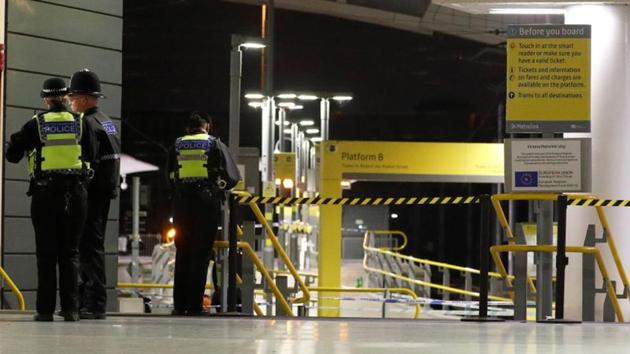Police officers stand at the end of a tram platform following a stabbing at Victoria Station in Manchester, Britain on January 1.(REUTERS)