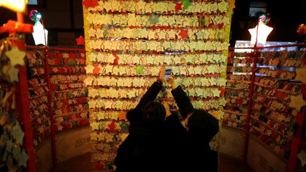 A couple hangs a message wishing for good luck for the New Year at a temple in Seoul, South Korea. (Kim Hong-Ji / Reuters) 