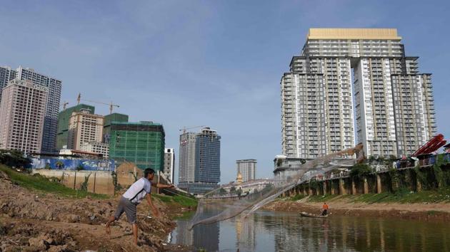 Unpredictable weather linked to climate change is laying waste to Cambodian fields. Saddled with debt from failed harvests, tens of thousands of farmers are turning to brick factories, where owners pay off their bills in exchange for labour. The factories feed a surging construction sector, with high-rises cropping up around the capital Phnom Penh and beyond as money -- much of it from China -- pours in. (Tang Chhin Sothy / AFP) Unpredictable weather linked to climate change is laying waste to Cambodian fields. Saddled with debt from failed harvests, tens of thousands of farmers are turning to brick factories, where owners pay off their bills in exchange for labour. The factories feed a surging construction sector, with high-rises cropping up around the capital Phnom Penh and beyond as money -- much of it from China -- pours in. (Tang Chhin Sothy / AFP)