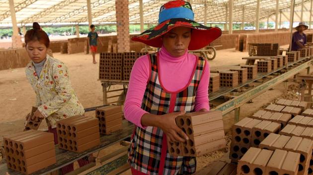 “I’m not going to school, I’m trying to help pay back the $4,000 that we owe, even if it will take years,” Bopha told AFP, as she loaded clay blocks on to a cart. “For 10,000 bricks transported, we receive $7.50.” Cambodian labour law prohibits those aged 12-15 from working if the job is hazardous or interferes with their education. Yet Bopha works all week with her family. (Tang Chhin Sothy / AFP) “I’m not going to school, I’m trying to help pay back the $4,000 that we owe, even if it will take years,” Bopha told AFP, as she loaded clay blocks on to a cart. “For 10,000 bricks transported, we receive $7.50.” Cambodian labour law prohibits those aged 12-15 from working if the job is hazardous or interferes with their education. Yet Bopha works all week with her family. (Tang Chhin Sothy / AFP)