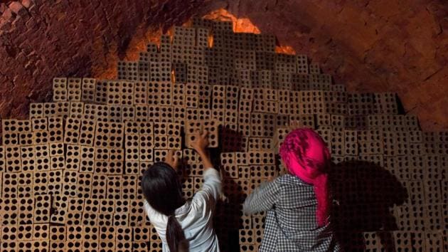 Cambodian women working at a brick factory on the outskirts of Phnom Penh. Bopha should be in school but instead toils seven days a week in a searing brick kiln on the outskirts of Phnom Penh -- a 14-year-old trapped in debt bondage in a boom industry preying on the poverty of Cambodia’s farmers. (Tang Chhin Sothy / AFP) Cambodian women working at a brick factory on the outskirts of Phnom Penh. Bopha should be in school but instead toils seven days a week in a searing brick kiln on the outskirts of Phnom Penh -- a 14-year-old trapped in debt bondage in a boom industry preying on the poverty of Cambodia’s farmers. (Tang Chhin Sothy / AFP)