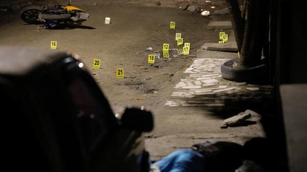 A man lies dead after a shooting in San Pedro Sula. It was one of many scenes Garrido witnessed while on assignment in Honduras, where thousands of people sought to escape violence and poverty by joining a migrant caravan in hope of making it to safety across the Mexico-US border. (Edgard Garrido / REUTERS) A man lies dead after a shooting in San Pedro Sula. It was one of many scenes Garrido witnessed while on assignment in Honduras, where thousands of people sought to escape violence and poverty by joining a migrant caravan in hope of making it to safety across the Mexico-US border. (Edgard Garrido / REUTERS)