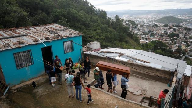 Relatives and friends of Ronald Blanco, carry the coffin during his funeral, outside his house. At Blanco’s funeral, he was stopped by a young man with piercing eyes, one green and one blue. He demanded to know why Garrido was there, pressing on with questions about what had brought him to Blanco’s funeral despite Garrido’s declaration of being a journalist. (Edgard Garrido / REUTERS) Relatives and friends of Ronald Blanco, carry the coffin during his funeral, outside his house. At Blanco’s funeral, he was stopped by a young man with piercing eyes, one green and one blue. He demanded to know why Garrido was there, pressing on with questions about what had brought him to Blanco’s funeral despite Garrido’s declaration of being a journalist. (Edgard Garrido / REUTERS)