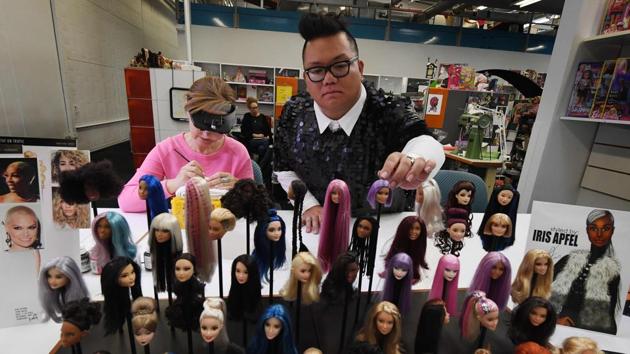 Stylist Carlyle Nuera (R) with Barbie prototype painter Alexandra Stoyan Lopez inspects prototypes at a workshop. In 1965, four years before Neil Armstrong walked on the Moon, Barbie became an astronaut. In 1968, the first black Barbie doll, a friend named Christie, hit store shelves. 55% of the dolls sold around the world have neither blonde hair nor blue eyes. (Mark Ralston / AFP) Stylist Carlyle Nuera (R) with Barbie prototype painter Alexandra Stoyan Lopez inspects prototypes at a workshop. In 1965, four years before Neil Armstrong walked on the Moon, Barbie became an astronaut. In 1968, the first black Barbie doll, a friend named Christie, hit store shelves. 55% of the dolls sold around the world have neither blonde hair nor blue eyes. (Mark Ralston / AFP)
