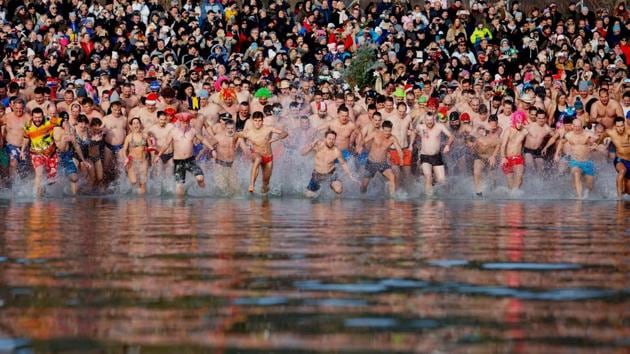 Swimmers run into the chilly waters of Lake Balaton during the 8th annual New Year’s swim in Szigliget, southwest of Budapest, Hungary. (Gyorgy Varga / MTI via AP) Swimmers run into the chilly waters of Lake Balaton during the 8th annual New Year’s swim in Szigliget, southwest of Budapest, Hungary. (Gyorgy Varga / MTI via AP)