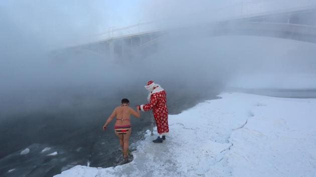 A man dressed as Ded Moroz, the Russian equivalent of Santa Claus, helps a member of the Cryophile amateur winter swimmers’ club walk into the icy waters of the Yenisei River during an event marking the New Year and Christmas season, with the air temperature at about minus 26 degrees Celsius in Krasnoyarsk, Russia. (Ilya Naymushin / REUTERS) A man dressed as Ded Moroz, the Russian equivalent of Santa Claus, helps a member of the Cryophile amateur winter swimmers’ club walk into the icy waters of the Yenisei River during an event marking the New Year and Christmas season, with the air temperature at about minus 26 degrees Celsius in Krasnoyarsk, Russia. (Ilya Naymushin / REUTERS)