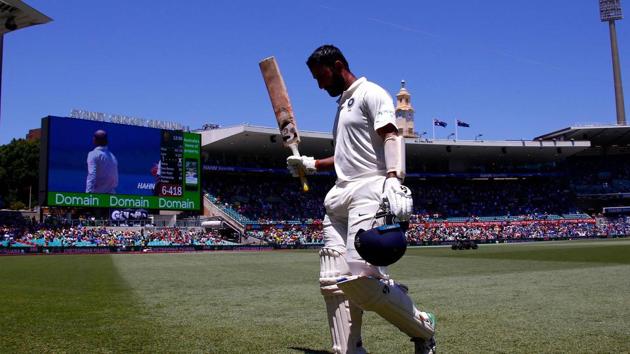 India's Cheteshwar Pujara reacts as he walks off the ground after being dismissed during the second day of the fourth and final cricket Test between India and Australia at the Sydney Cricket Ground.(AFP)