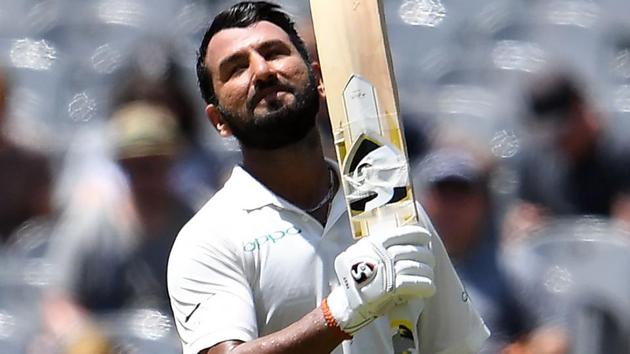 Cheteshwar Pujara (C) celebrates after reaching his century.(AFP)