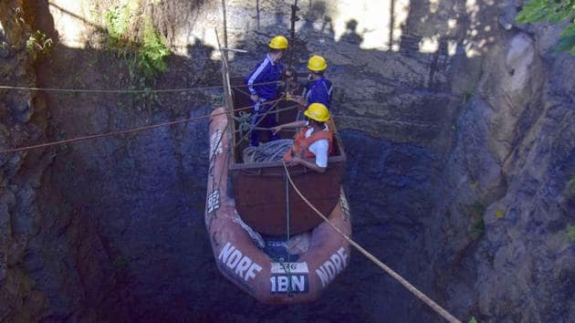 In this file photo taken on December 30, 2018 Indian Navy divers are lowered into a mine with a pulley during rescue operations to help 15 miners trapped by flooding in an illegal coal mine in Ksan village in Meghalaya's East Jaintia Hills district.(AFP File Photo)