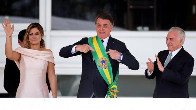 Brazil’s new President Jair Bolsonaro gestures after receiving the presidential sash from outgoing President Michel Temer at the Planalto Palace, in Brasilia, Brazil. (Sergio Moraes / REUTERS) Brazil’s new President Jair Bolsonaro gestures after receiving the presidential sash from outgoing President Michel Temer at the Planalto Palace, in Brasilia, Brazil. (Sergio Moraes / REUTERS)