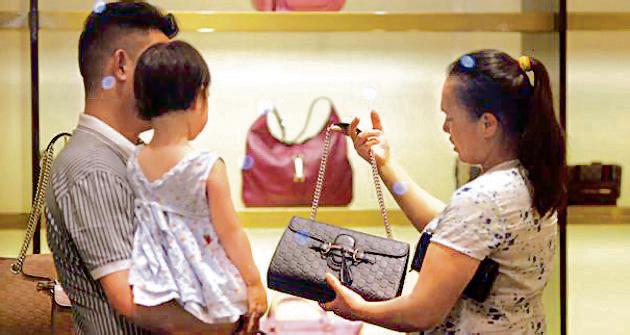 A woman shops for handbags at a Gucci luxury boutique at the IFC Mall in Shanghai. If China were to continue on the same trajectory in terms of nominal GDP growth and domestic consumption, its consumer spending could increase by another $2 trillion by 2020, putting it at around half that of the US. (Reuters File) A woman shops for handbags at a Gucci luxury boutique at the IFC Mall in Shanghai. If China were to continue on the same trajectory in terms of nominal GDP growth and domestic consumption, its consumer spending could increase by another $2 trillion by 2020, putting it at around half that of the US. (Reuters File)