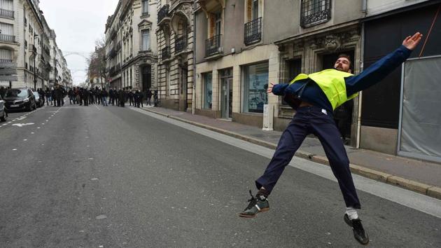 A protestor dances in front of French riot police during a demonstration called by the yellow vests (gilets jaunes) movement, to protest against the rising costs of living they blame on high taxes, in downtown Nantes, western France. (Jean-Francois Monier / AFP) A protestor dances in front of French riot police during a demonstration called by the yellow vests (gilets jaunes) movement, to protest against the rising costs of living they blame on high taxes, in downtown Nantes, western France. (Jean-Francois Monier / AFP)