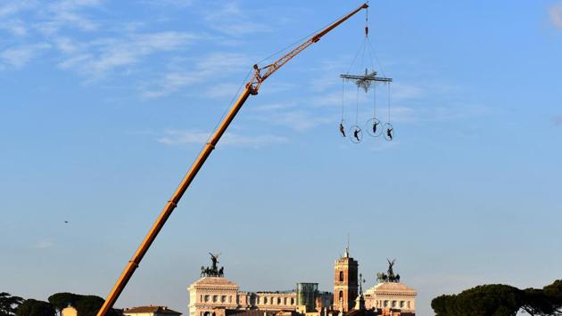 Aerial dancers of the Kitonb theater group, hanging from a crane, perform during rehearsals ahead of their New Year's show at the Circus Maximus in Rome, Italy. (Alberto Pizzoli / AFP) Aerial dancers of the Kitonb theater group, hanging from a crane, perform during rehearsals ahead of their New Year's show at the Circus Maximus in Rome, Italy. (Alberto Pizzoli / AFP)