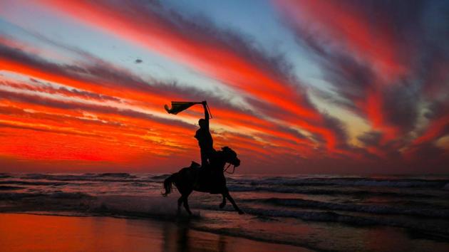 A Palestinian horseman rides on the beach at sunset a few hours prior to the New Year’s celebrations in Gaza city, Palestine. (Mahmud Hams / AFP) A Palestinian horseman rides on the beach at sunset a few hours prior to the New Year’s celebrations in Gaza city, Palestine. (Mahmud Hams / AFP)