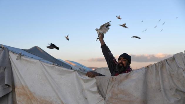 A displaced Syrian man holds a bird in a flooded camp near Dayr Ballut, Aleppo province, in northwestern Syria. Torrential rains have washed away hundreds of tents in camps sheltering displaced Syrians in the north of the war-wracked country, aid groups have said, as residents pleaded for help. (Rami al Sayed / AFP) A displaced Syrian man holds a bird in a flooded camp near Dayr Ballut, Aleppo province, in northwestern Syria. Torrential rains have washed away hundreds of tents in camps sheltering displaced Syrians in the north of the war-wracked country, aid groups have said, as residents pleaded for help. (Rami al Sayed / AFP)