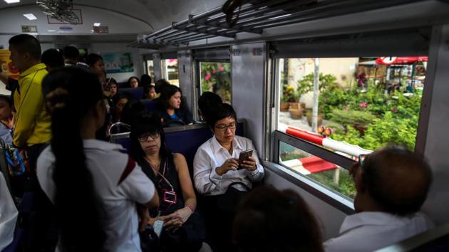 Boodsabann Chanthawong, 49, a businesswoman, works on her mobile phone as she rides on a train, weeks ahead of her ordination. “I’m going to overcome this obstacle and become ordained like I’ve always wanted,” the 49-year-old businesswoman said before the ceremony on Dec. 5, where she would have her head shaved. She stayed for nine days at the temple. (Athit Perawongmetha / REUTERS) Boodsabann Chanthawong, 49, a businesswoman, works on her mobile phone as she rides on a train, weeks ahead of her ordination. “I’m going to overcome this obstacle and become ordained like I’ve always wanted,” the 49-year-old businesswoman said before the ceremony on Dec. 5, where she would have her head shaved. She stayed for nine days at the temple. (Athit Perawongmetha / REUTERS)