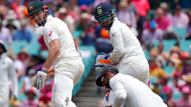 Australia's Shaun Marsh (L) reacts as he is caught by India's Ajinkya Rahane during the third day's play of the fourth and final cricket Test between India and Australia at the Sydney Cricket Ground.(AFP)