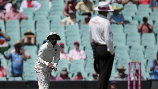 KL Rahul, left, signals to the umpire that he had not made a catch against Australia.(AP)