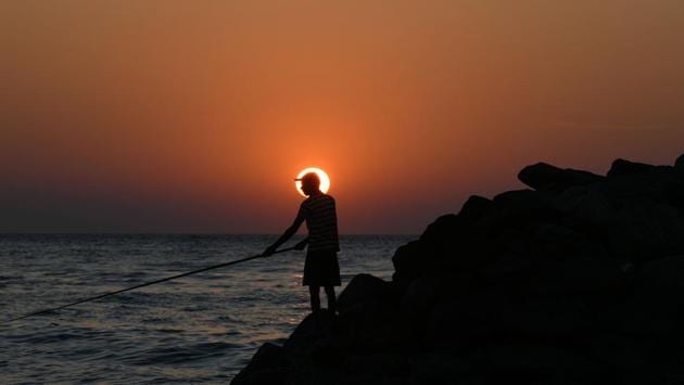 A Sri Lankan man fishes during sunset on a beach in Colombo. (Lakruwan Wanniarachchi / AFP) A Sri Lankan man fishes during sunset on a beach in Colombo. (Lakruwan Wanniarachchi / AFP)