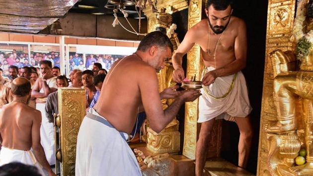Priests carry out ‘purification’ of the Lord Ayyappa Temple after two women in their early 40s entered the shrine and offered prayers, in Sabarimala, Kerala. (PTI) Priests carry out ‘purification’ of the Lord Ayyappa Temple after two women in their early 40s entered the shrine and offered prayers, in Sabarimala, Kerala. (PTI)