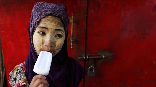 A girl eats a popsicle during Myanmar’s 71st Independence Day in Yangon, Myanmar. (Ann Wang / REUTERS) A girl eats a popsicle during Myanmar’s 71st Independence Day in Yangon, Myanmar. (Ann Wang / REUTERS)