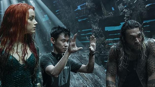 James Wan (C), with actors Amber Heard and Jason Momoa on the set of Aquaman.