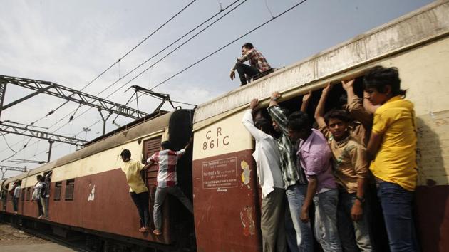 Crowds hanging out of a crowded harbour line train at Kurla ( harbour side ) on Wednesday afternoon, after a pantograph broke at Kurla causing delay in train schedules on the harbour line in Mumbai, India, on Wednesday, Jan. 30, 2013. (Photo by Vijayanand Gupta / Hindustan Times)(Hindustan Times)