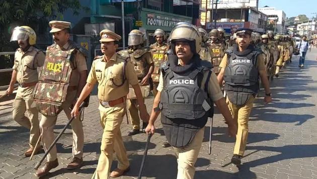 Police personnel carried out a march in trouble-torn Thalassery in Kannur district on Saturday after widespread violence rocked the area. Houses of an MP, MLA and many party leaders (both RSS and CPI(M)) were attacked in the latest bout of violence fuelled by unrest in Sabarimala.(HT Photo)