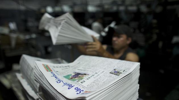 A recent edition of the Sao Paulo Shimbun is stacked into piles before delivery in Sao Paulo, Brazil. For decades this newspaper, from its offices in Sao Paulo’s Asian neighbourhood of Liberdade, served as the main reference point for Japanese living in the South American country. While mainly in Japanese, it printed a few pages in Portuguese as well. January 01 marked the end of a 72-year run. (Victor R. Caivano / AP) A recent edition of the Sao Paulo Shimbun is stacked into piles before delivery in Sao Paulo, Brazil. For decades this newspaper, from its offices in Sao Paulo’s Asian neighbourhood of Liberdade, served as the main reference point for Japanese living in the South American country. While mainly in Japanese, it printed a few pages in Portuguese as well. January 01 marked the end of a 72-year run. (Victor R. Caivano / AP)