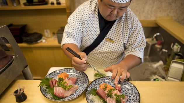 While slicing fish at a restaurant, sushi chef Hiro Konno said: “I don’t think we should disconnect so much (from Japanese culture). Those of us who have Japanese roots should do more to preserve them. For me, the closing of the newspaper is very sad.” (Victor R. Caivano / AP) While slicing fish at a restaurant, sushi chef Hiro Konno said: “I don’t think we should disconnect so much (from Japanese culture). Those of us who have Japanese roots should do more to preserve them. For me, the closing of the newspaper is very sad.” (Victor R. Caivano / AP)