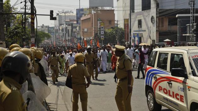 Policemen guard a march by Bharatiya Janata Party activists as part of a strike call by Sabarimala Karma Samithi, an umbrella organization of Hindu groups, in Thiruvananthapuram, capital of the southern Indian state of Kerala, Thursday, Jan. 3, 2019. Hindu hard-liners shut shops and businesses and clashed with police in the state Thursday to protest the entry of two women in one of India's largest Hindu pilgrimage sites. (File Photo) (AP) Policemen guard a march by Bharatiya Janata Party activists as part of a strike call by Sabarimala Karma Samithi, an umbrella organization of Hindu groups, in Thiruvananthapuram, capital of the southern Indian state of Kerala, Thursday, Jan. 3, 2019. Hindu hard-liners shut shops and businesses and clashed with police in the state Thursday to protest the entry of two women in one of India's largest Hindu pilgrimage sites. (File Photo) (AP)