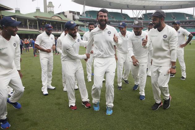 India's Virhat Kohli, right, encourages Cheteshwar Pujara, center, as the team dance as they celebrate their series win over Australia after play was called off on day 5 of their cricket test match in Sydney, Monday, Jan. 7, 2019. The match is a draw and India wins the series 2-1. (AP Photo/Rick Rycroft) (AP)