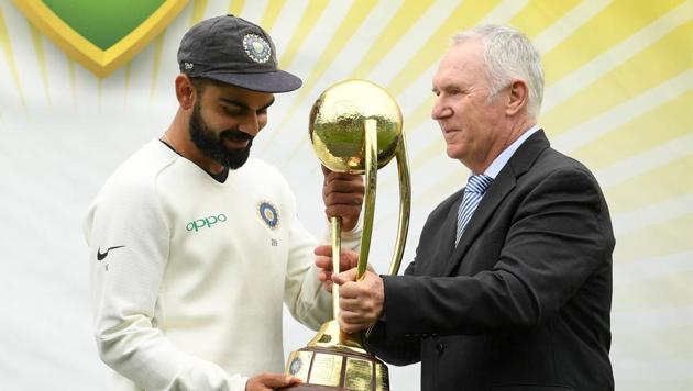 Virat Kohli recieves the Border-Gavaskar trophy from Allan Border. (REUTERS) Virat Kohli recieves the Border-Gavaskar trophy from Allan Border. (REUTERS)