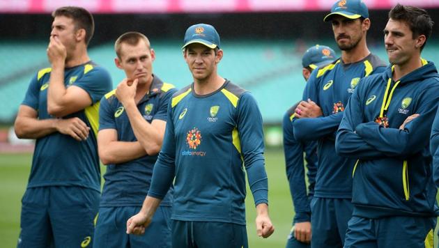 Australia's captain Tim Paine (C) watches on with teammates as India celebrates a 2-1 series victory following play being abandoned on day five in the fourth test match between Australia and India(REUTERS)