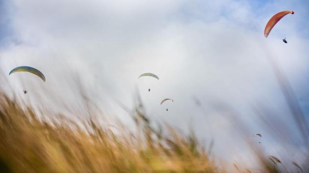 On a mountain slope overlooking Hong Kong, Giovanni Lam waited for the right gust of wind to send him soaring skywards, one of a growing number of paragliders using flight to escape the dense urban sprawl below. (Anthony Wallace / AFP) On a mountain slope overlooking Hong Kong, Giovanni Lam waited for the right gust of wind to send him soaring skywards, one of a growing number of paragliders using flight to escape the dense urban sprawl below. (Anthony Wallace / AFP)