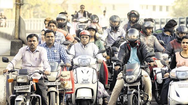 The traffic department claims that crackdown is proving to be a success. Here, most of the riders on Karve road are seen wearing helmets.(RAVINDRA JOSHI/HT PHOTO)