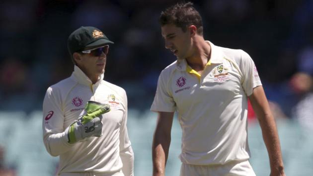 Australia's captain Tim Paine, left, gives instructions to his bowler Pat Cummins during a Test match.(AP)