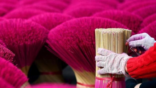 Sales tick up every year ahead of and during the Tet lunar new year in February, when throngs of people crowd into temples to light incense during worship, or burn the sticks on the ancestral altar at home. (Manan Vatsyayana / AFP) Sales tick up every year ahead of and during the Tet lunar new year in February, when throngs of people crowd into temples to light incense during worship, or burn the sticks on the ancestral altar at home. (Manan Vatsyayana / AFP)