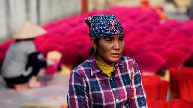“It is a traditional and spiritual job making these sticks,” Dang Thi Hoa told AFP, sitting amid bundles of bright pink incense sticks drying under the afternoon sun. Her village is among several dotted across Vietnam making the sticks, the scent of each batch tailored to the tastes of regions they will be sold in. (Manan Vatsyayana / AFP) “It is a traditional and spiritual job making these sticks,” Dang Thi Hoa told AFP, sitting amid bundles of bright pink incense sticks drying under the afternoon sun. Her village is among several dotted across Vietnam making the sticks, the scent of each batch tailored to the tastes of regions they will be sold in. (Manan Vatsyayana / AFP)